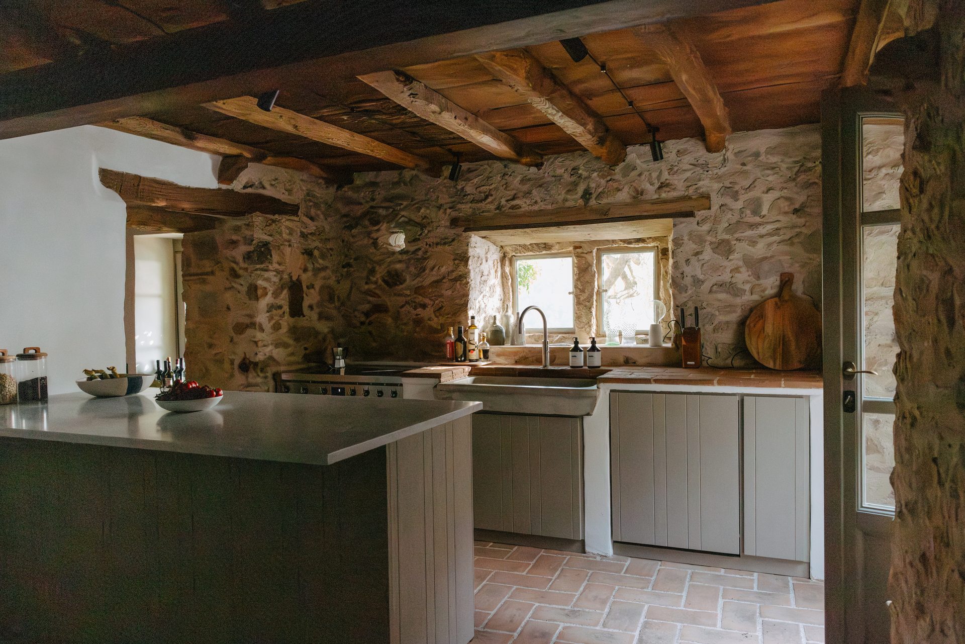 The finished kitchen beneath the old timber beams